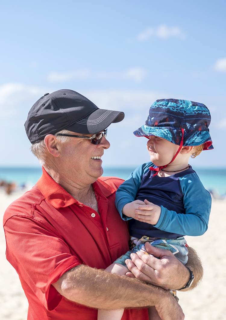 Man and toddler on beach